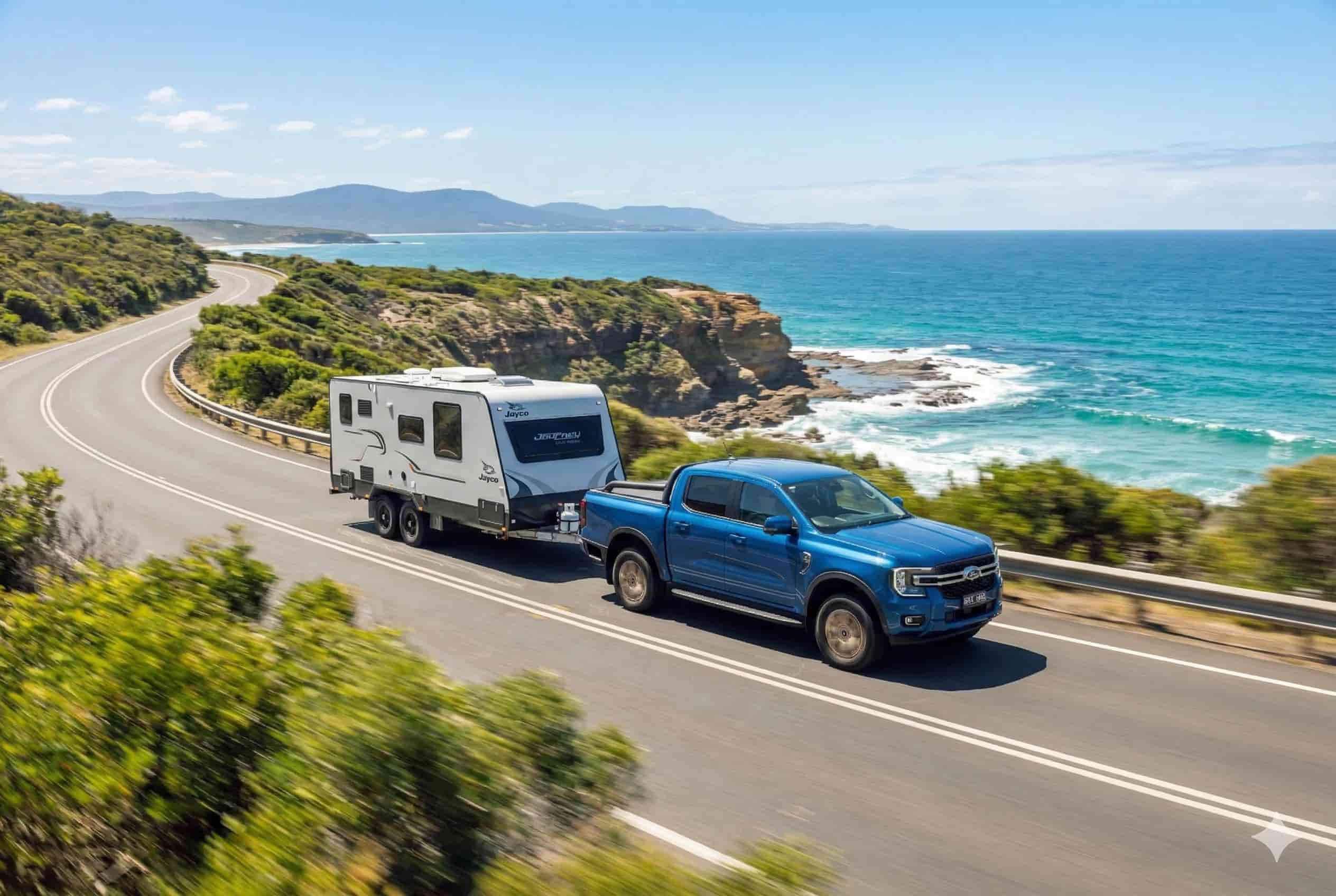 Ute towing a caravan on an Australian coastal road